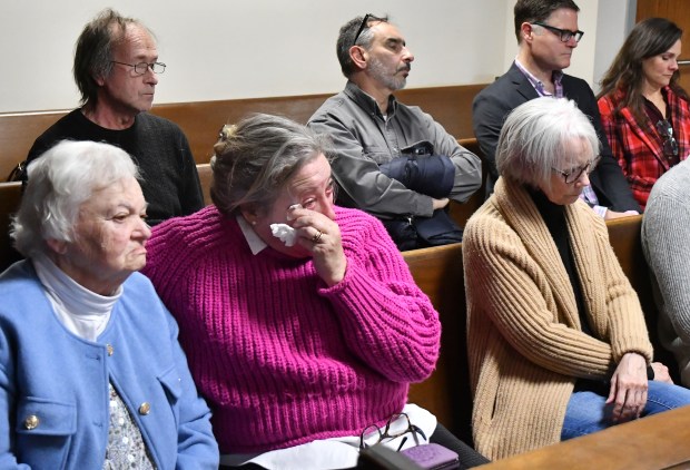 usan Kenney whose father Charles Lowell died in the soldiers home COVID outbreak wipes tears from her eyes during Bennett Walsh's change of plea hearing in Hampshire County Court. At left is her mother Alice Lowell. (Chris Christo/Boston Herald)