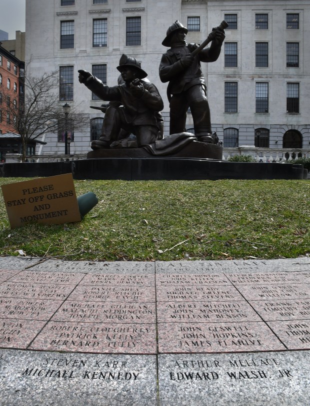 The names of Firefighter Michael Kennedy and Fire Lt. Edward Walsh Jr. appear among hundreds of others at the Massachusetts Fallen Firefighters Memorial next to the Statehouse.(Chris Christo/Boston Herald)