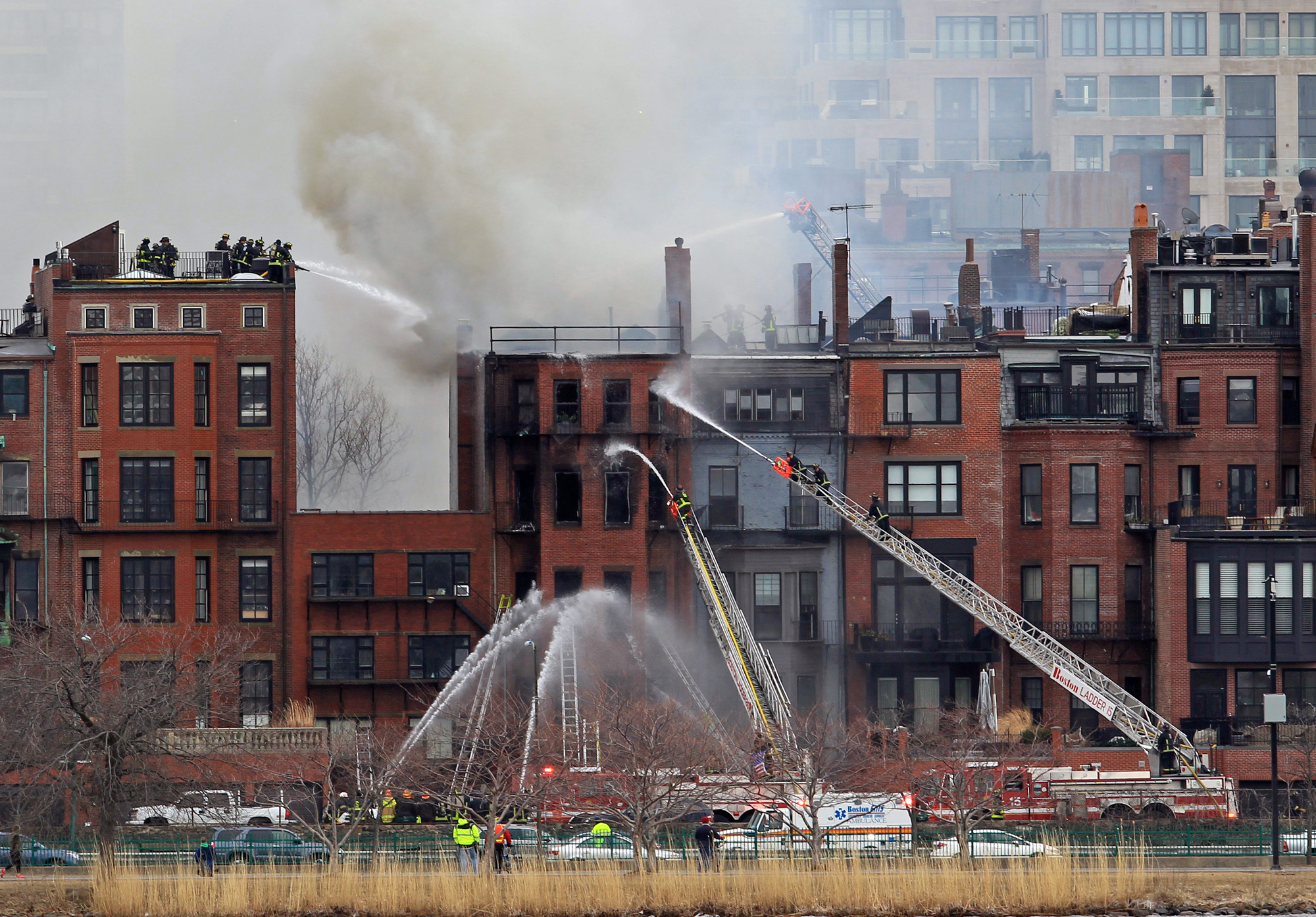 Fire crews can be seen in a massive response to the fatal 9-alarm fire on Beacon Street in Boston, as seen in this photo taken from Cambridge on March 26, 2014. (Stuart Cahill/Boston Herald, File)