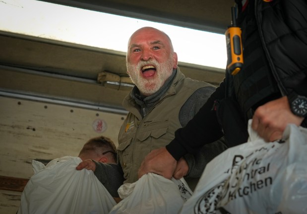 FILE - Jose Andres, a Spanish chef, and founder of World Central Kitchen unloads the humanitarian food packages delivered with WCK's truck in Kherson, Ukraine, on Nov. 15, 2022. World Central Kitchen, called a halt to its work in the Gaza Strip after an apparent Israeli strike killed seven of its workers, mostly foreigners. (AP Photo/Efrem Lukatsky, File)