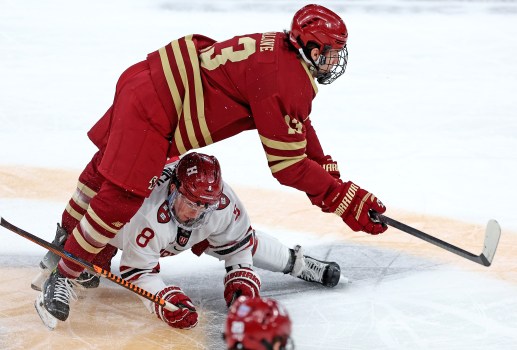 Boston College forward Jack Malone #13, defended by Harvard forward Alex Gaffney #8 during the first period of the Beanpot Consolation Game at the Garden, scored the OT winner Sunday against Quinnipiac. (Matt Stone/Boston Herald)