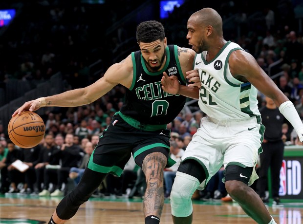 Celtics forward Jayson Tatum, left, drives against Khris Middleton of the Milwaukee Bucks during Boston's win Wednesday. (Matt Stone/Boston Herald)