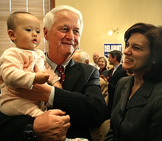 Congressman William Delahunt walks with Vicki Kennedy as he makes his way through the crowd with his 9 month old granddaughter, Maya Bobrov, after announcing that he won't be running for re-election.