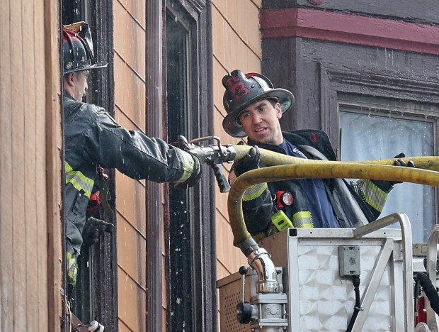 Firefighters work at the scene of a fatal six-alarm fire on Meridian Street in East Boston, Tuesday. (Matt Stone/Boston Herald)