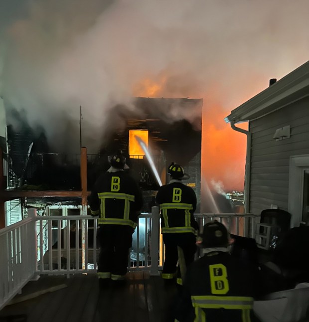 Firefighters attack a fatal six-alarm fire on Meridian Street in East Boston, Tuesday. (BFD photo)