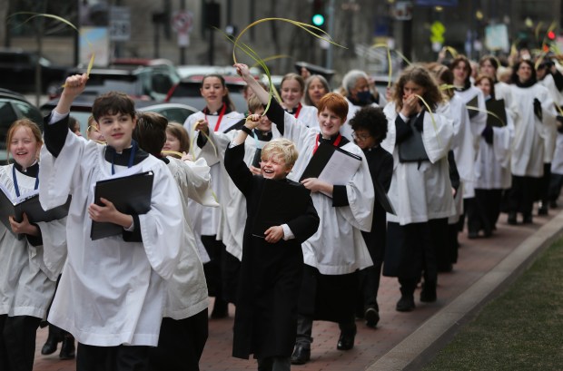 Members of the choir process waving palms during a Palm Sunday procession at Trinity Church Sunday. (Nancy Lane/Boston Herald)