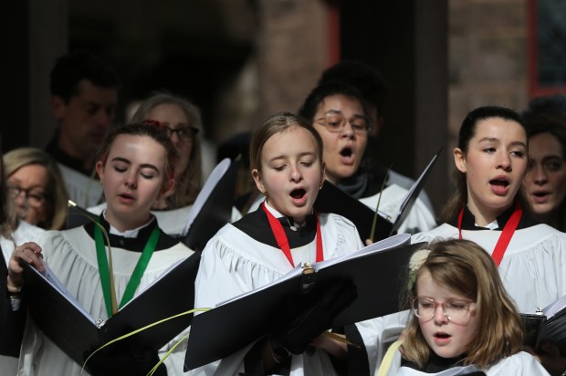 Members of the choir sing during Palm Sunday at Trinity Church.