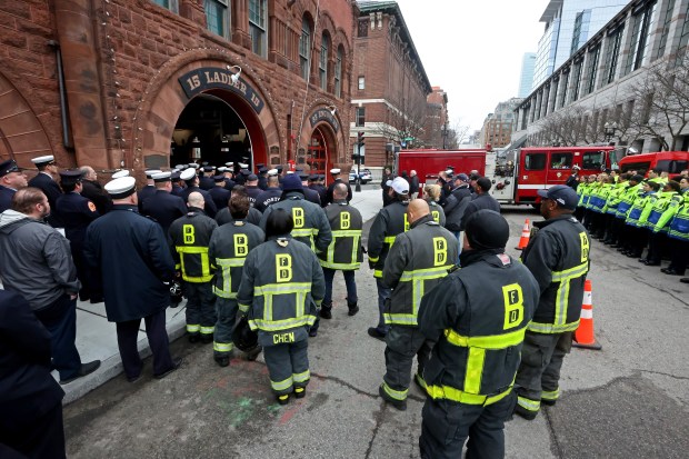 A line of mourners from BFD stretch out of the station during a memorial held at the station for Engine 33 and Ladder 15 for firefighters that lost their lives 10 years ago at the 298 Beacon st fire on March 26. (Staff Photo By Stuart Cahill/Boston Herald)