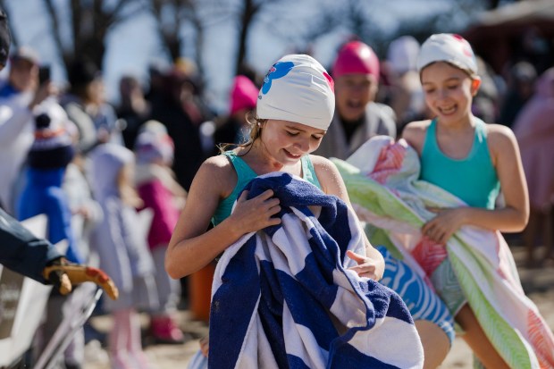 Weston's Samantha Hall towels off after taking the "Plunge for Elodie" at Morses Pond in Wellesley. (Libby O'Neill/Boston Herald)