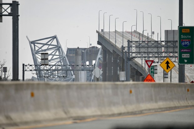 Part of the fallen structure of Key Bridge is viewed from press staging area on Authority Drive in Dundalk (Kenneth K. Lam/Staff)