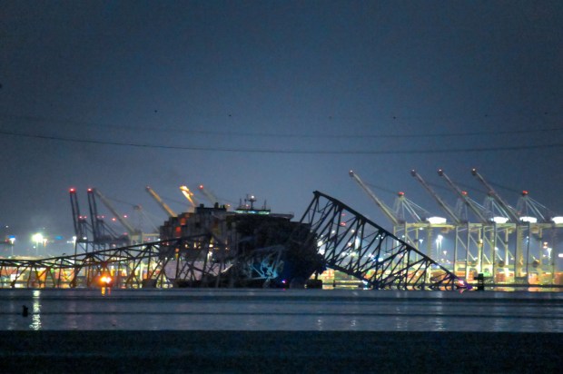 The Francis Scott Key Bridge lies in ruins in the waters of the Patapsco River after a container ship collided with the structure overnight. (Karl Merton Ferron/Staff)