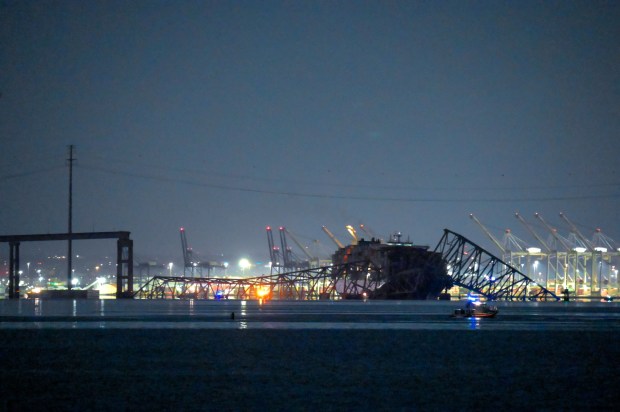 The Francis Scott Key Bridge lies in ruins in the waters of the Patapsco River after a container ship collided with the structure overnight. (Karl Merton Ferron/Staff)