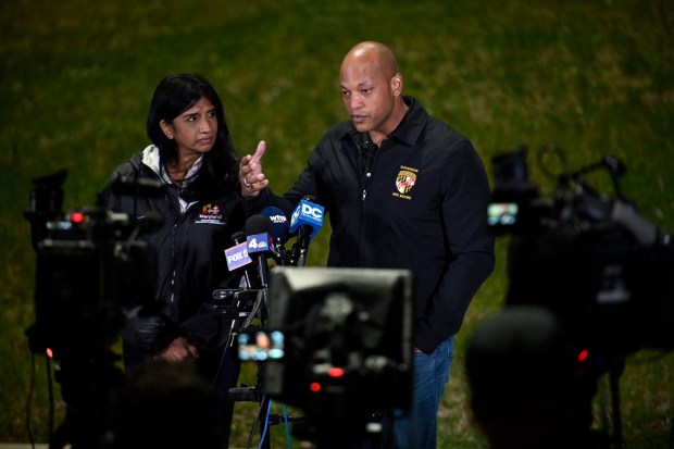 Gov. Wes Moore, center, and Lt. Gov. Aruna Miller answer questions during a press conference near the site of the collapsed Francis Scott Key Bridge after a support column was struck by a container ship collapsed early Tuesday morning. This is their third news conference of the day. (Kenneth K. Lam/Staff)