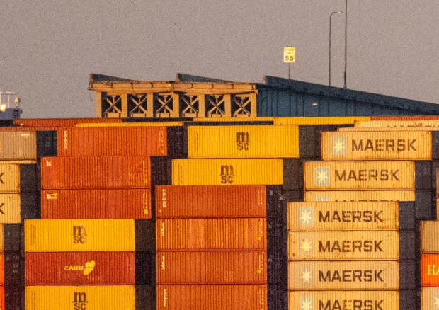 A speed limit sign is seen above the Maersk container ship Dali and the remains of the collapsed Francis Scott Key Bridge. The massive container ship was adrift early Tuesday as it headed toward the iconic Francis Scott Key Bridge, losing power before colliding with one of the bridge's support columns. (Jerry Jackson/Staff)