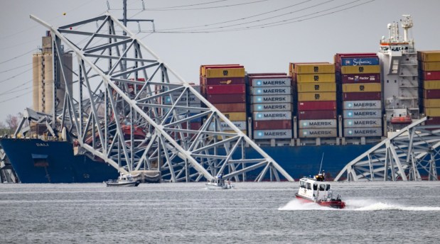 First responders search for victims in the remains of the collapsed Francis Scott Key Bridge. The massive container ship Dali lost power before colliding with one of the bridge's support columns early Tuesday. (Jerry Jackson/Staff)