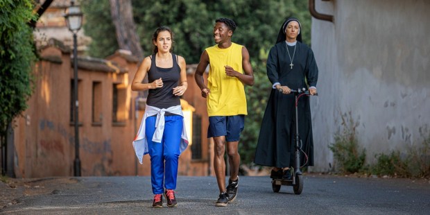 Cristina Rodlo's Rosita, left, and Sheyi Cole's Jason go for a run in a scene from "The Beautiful Game." (Courtesy of Netflix)