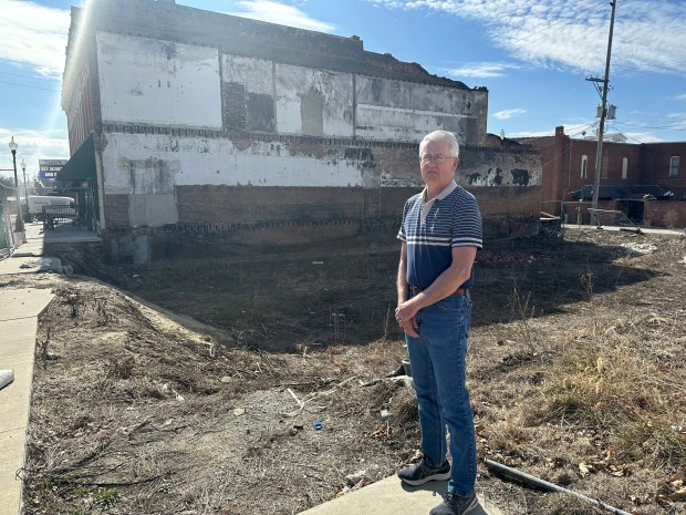Tom Mulholland stands near the site where a 2021 fire destroyed Mulholland Grocery, long a staple of Main Street in Malvern, Iowa. (Kevin Hardy/Stateline/TNS)